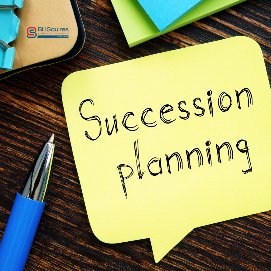 A yellow Post-It note on a wooden background with Succession planning written on it